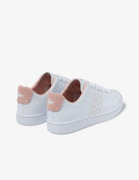 Zapatillas blancas con talón rosa.