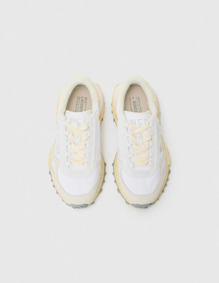 Zapatillas Lacoste blancas sobre fondo blanco.